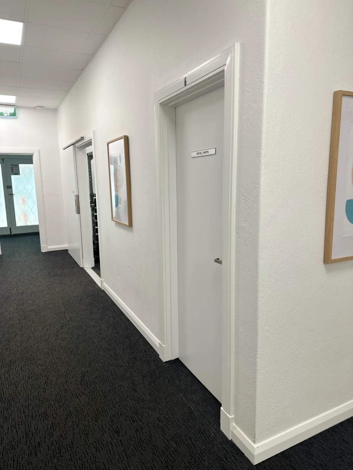 Consulting room doors along the Adelaide Health Group corridor, each named for the doctor who works there